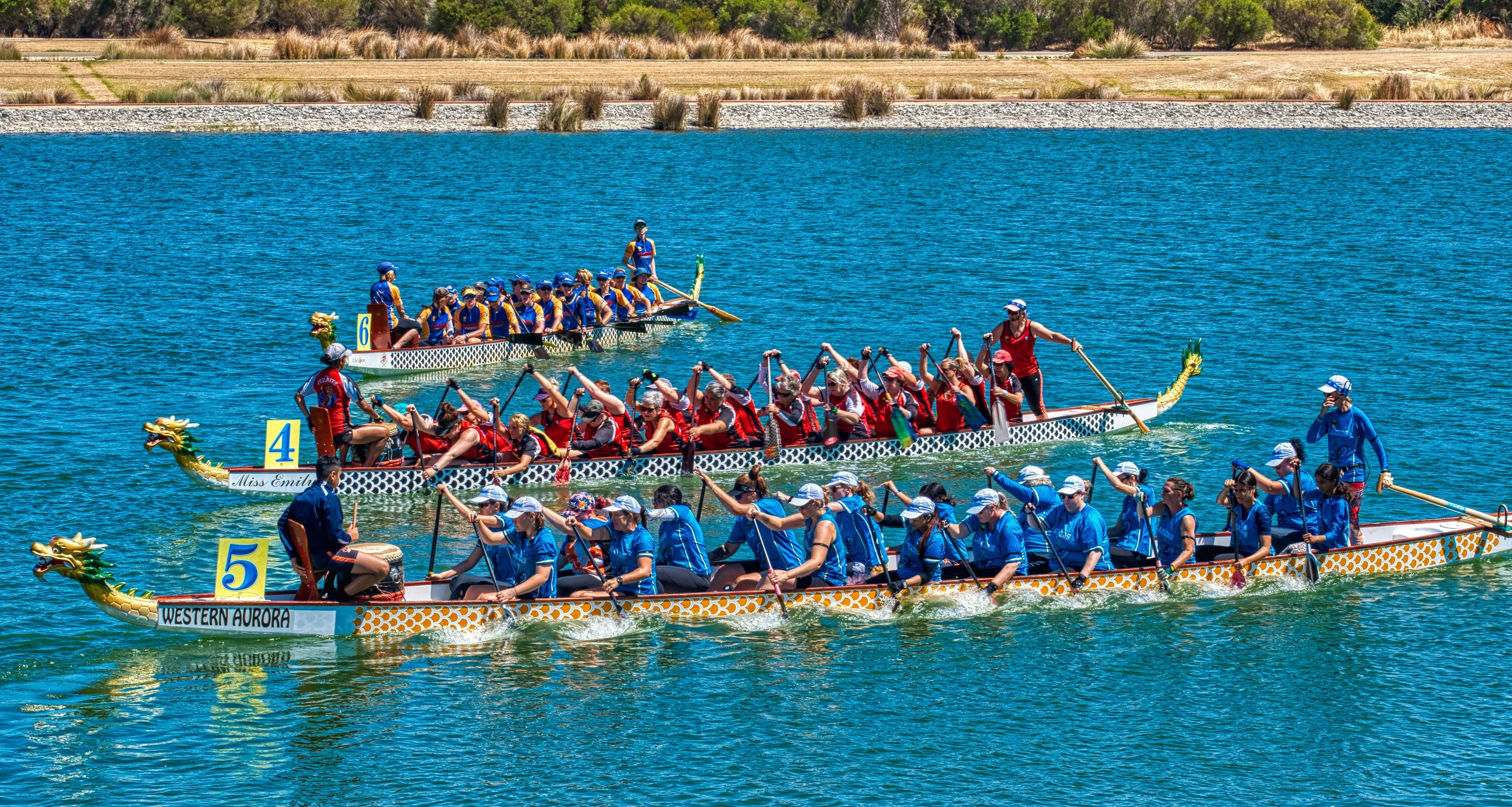 A photo of three dragonboats preparing to begin a race at the Champion Lakes Regatta Centre in Champion Lakes, Perth